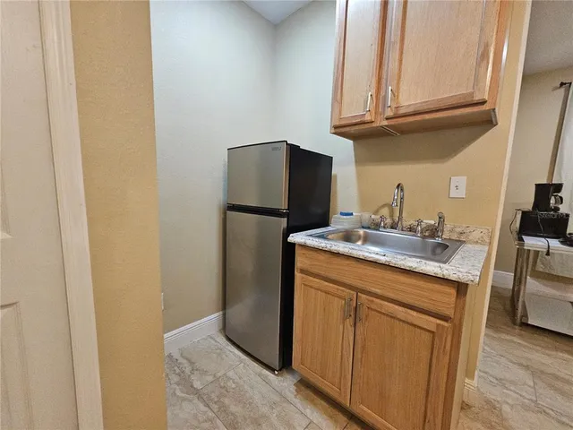 a kitchen with a refrigerator and a sink