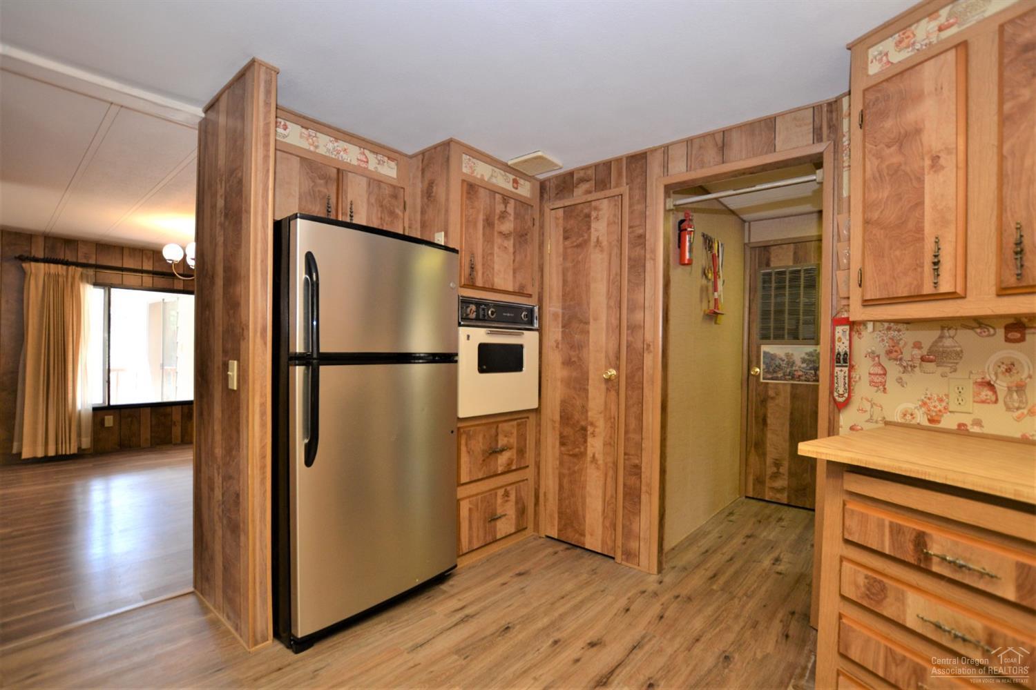 60176 Agate Road Bend, OR 97702 - Photo 10 of 21 a kitchen with stainless steel appliances granite countertop a refrigerator and a stove top oven
