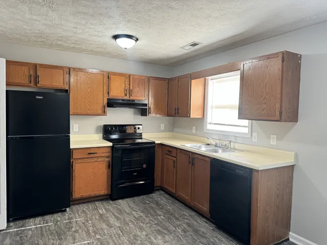 a kitchen with a refrigerator and a sink