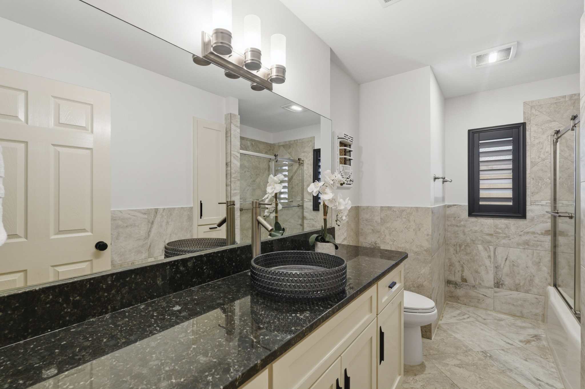 2302 Chimney Rock Road Houston, TX 77056 - Photo 20 of 28 Secondary hallway bathroom has been updated but preserved the timeless character. Check out the vintage beautifully preserved original heat lamp above the toilet. There are little gems throughout the home showcasing this 1953 ranch homes charm!