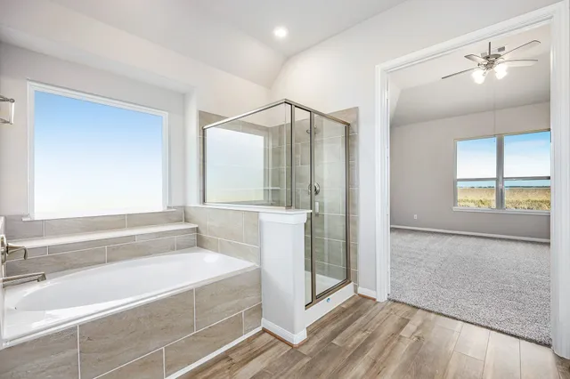 a spacious bathroom with a bathtub and a shower