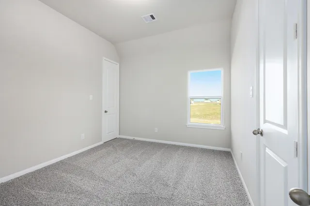 a view of an empty room and a window