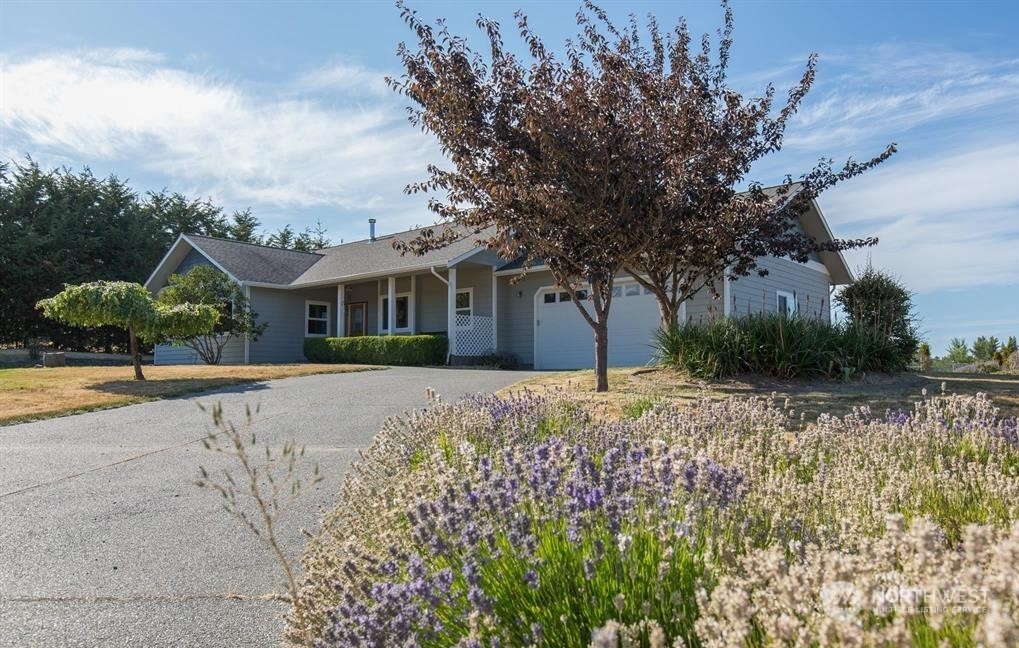 2493 Atterberry Road Sequim, WA 98382 - Photo 1 of 29 a front view of a house with garden
