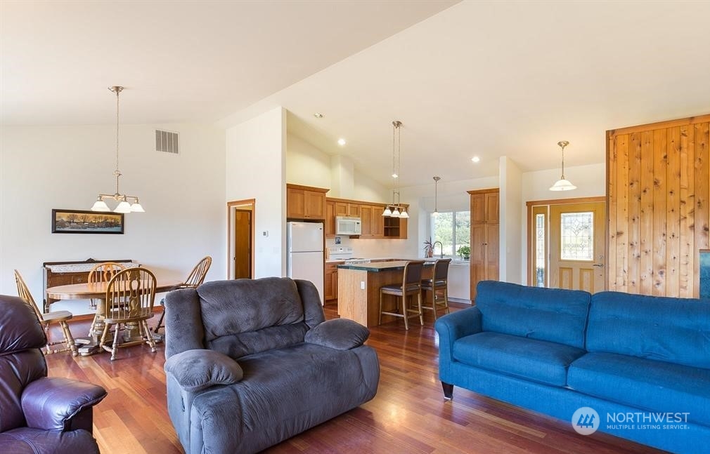 2493 Atterberry Road Sequim, WA 98382 - Photo 15 of 29 a living room with furniture kitchen view and a wooden floor