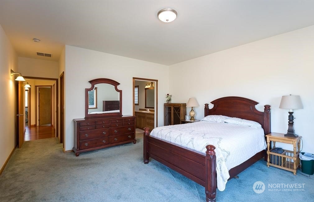 2493 Atterberry Road Sequim, WA 98382 - Photo 22 of 29 a bedroom with a bed and a dresser