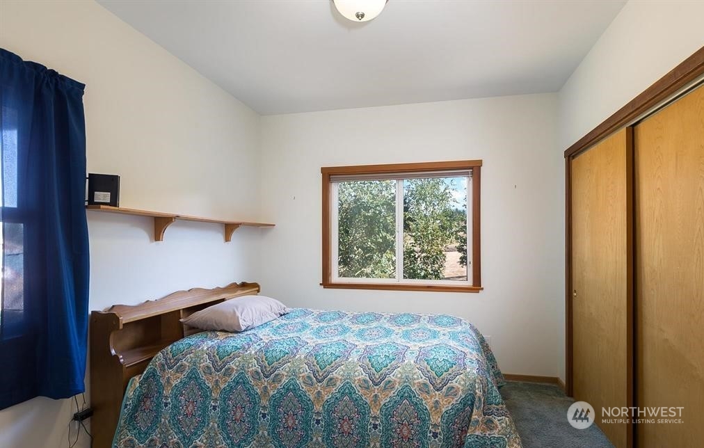 2493 Atterberry Road Sequim, WA 98382 - Photo 26 of 29 a bedroom with a bed and a window