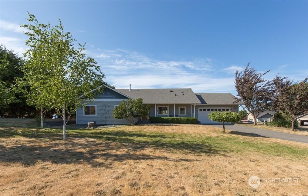 2493 Atterberry Road Sequim, WA 98382 - Photo 6 of 29 a front view of a house with a yard