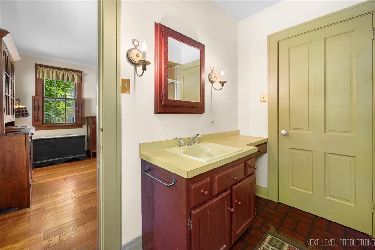 301 South 1st Street Geneva, IL 60134 - Photo 14 of 25 a bathroom with a sink and a mirror