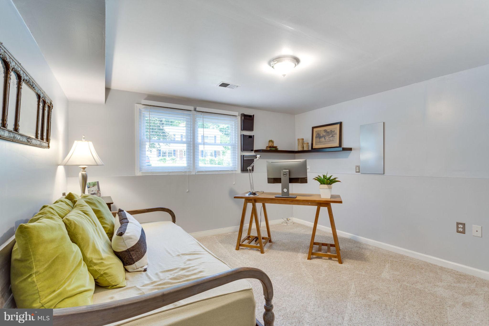 9147 Rockefeller Lane Springfield, VA 22153 - Photo 26 of 30 a bedroom with a bed and a table in it