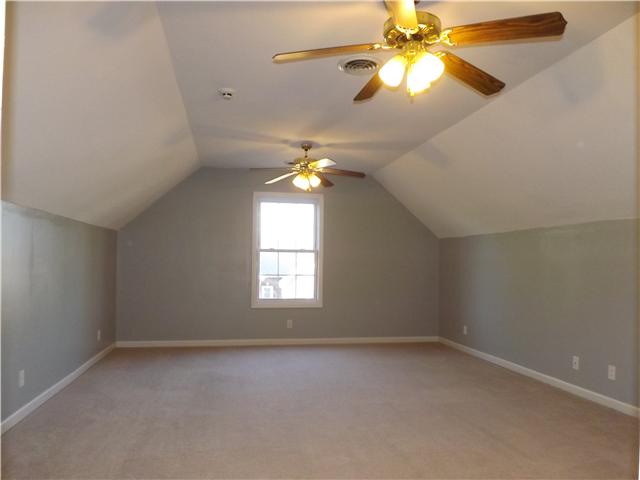 124 Foxrun Springfield, TN 37172 - Photo 16 of 20 Bonus room with high knee walls and two ceiling fans.