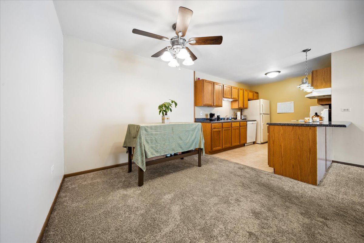 935 Golf Course Road, Unit 1 Crystal Lake, IL 60014 - Photo 4 of 10 a view of a kitchen with a sink and a refrigerator
