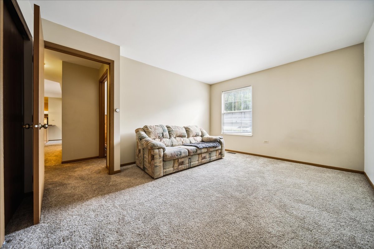 935 Golf Course Road, Unit 1 Crystal Lake, IL 60014 - Photo 7 of 10 a living room with furniture and a window