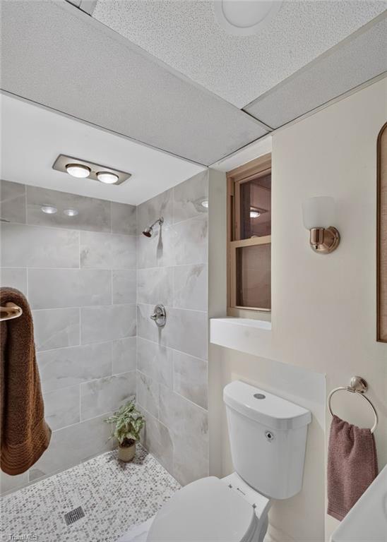 113 Green Valley Road Greensboro, NC 27403 - Photo 37 of 46 A full bathroom on the lower level adds convenience for guests and entertaining.