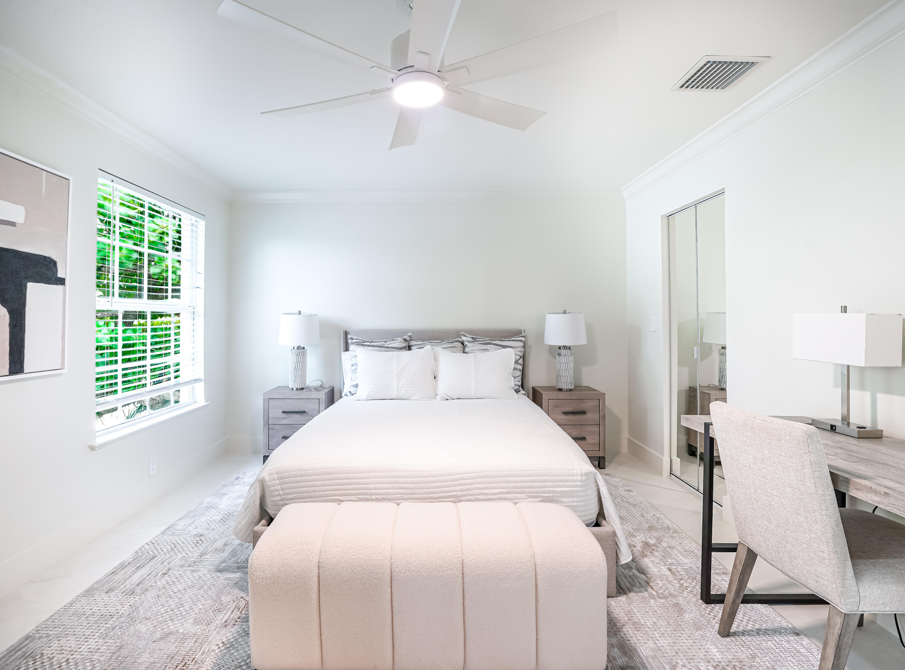 749 Northeast 71st Street Boca Raton, FL 33487 - Photo 30 of 43 a bedroom with a bed a chair and a large window