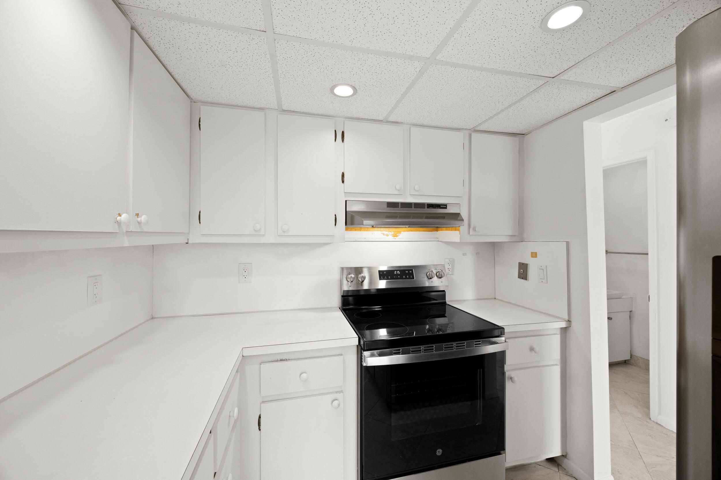 1401 South Federal Highway, Unit 220 Boca Raton, FL 33432 - Photo 12 of 27 a kitchen with stainless steel appliances granite countertop white cabinets and a stove top oven