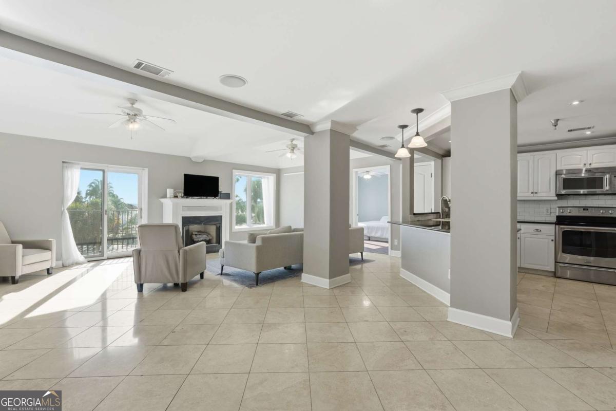 700 Wilmington Island Road, Unit 201 Savannah, GA 31410 - Photo 12 of 51 a large white kitchen with cabinets and furniture
