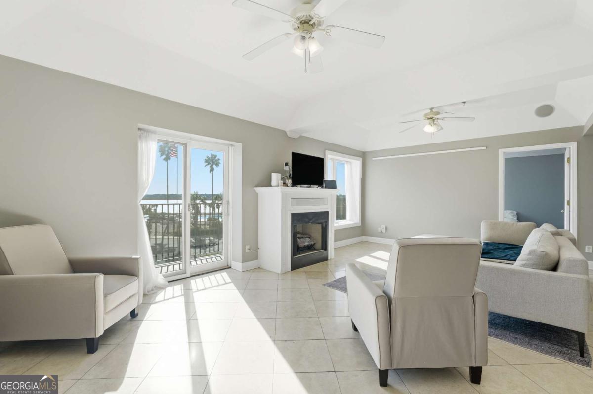 700 Wilmington Island Road, Unit 201 Savannah, GA 31410 - Photo 13 of 51 a living room with furniture and a fireplace