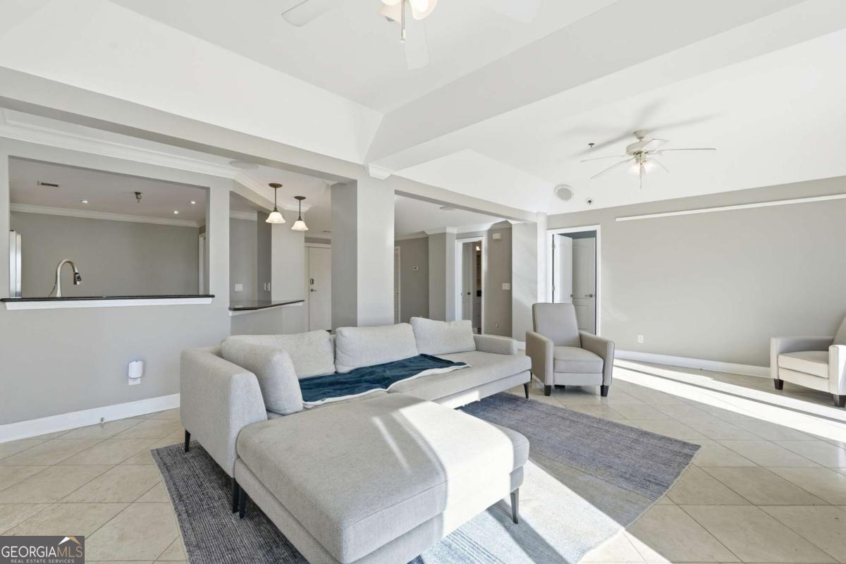 700 Wilmington Island Road, Unit 201 Savannah, GA 31410 - Photo 16 of 51 a living room with furniture and a chandelier