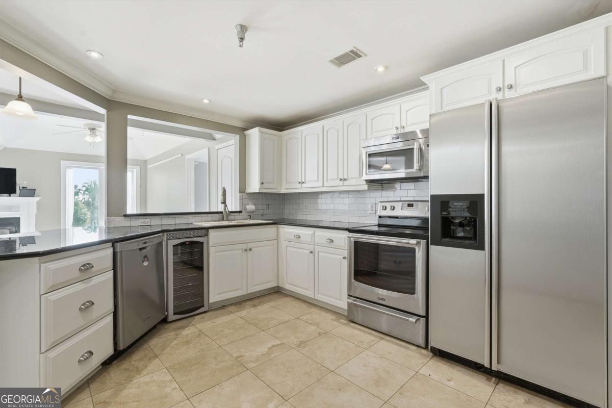 700 Wilmington Island Road, Unit 201 Savannah, GA 31410 - Photo 18 of 51 a kitchen with stainless steel appliances and white cabinets