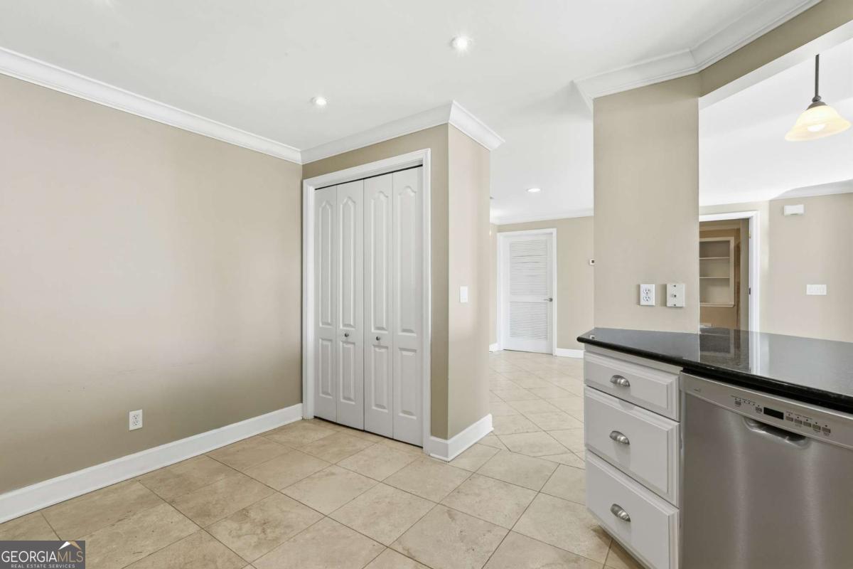 700 Wilmington Island Road, Unit 201 Savannah, GA 31410 - Photo 20 of 51 a spacious bathroom with a granite countertop sink a mirror and a