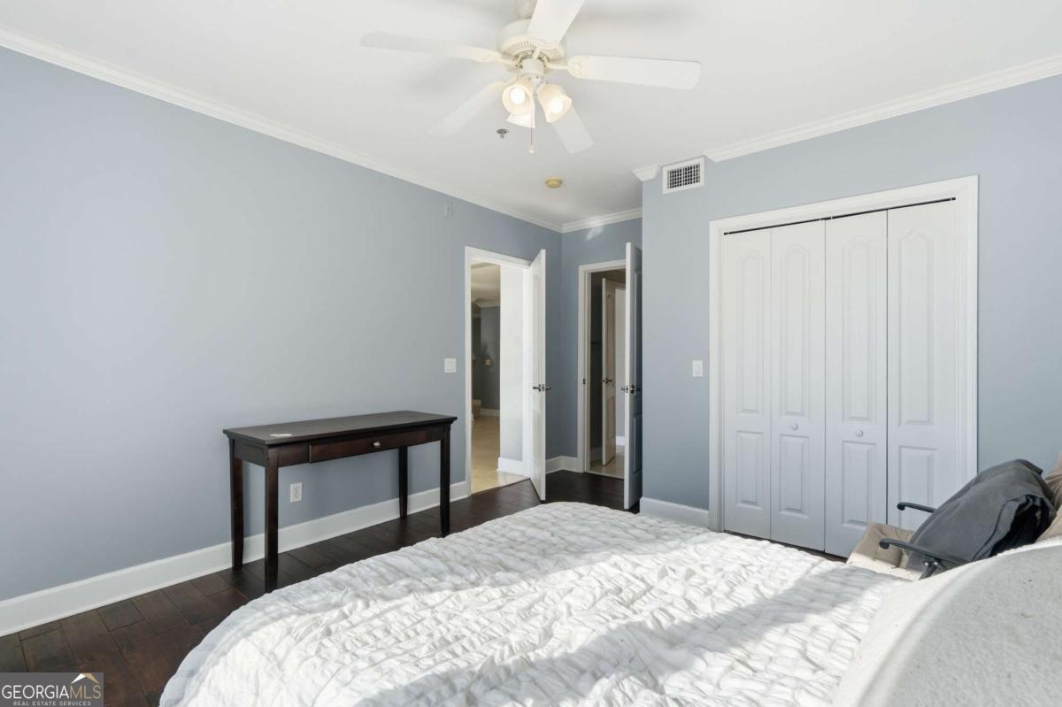 700 Wilmington Island Road, Unit 201 Savannah, GA 31410 - Photo 27 of 51 a bedroom with a bed and a chandelier
