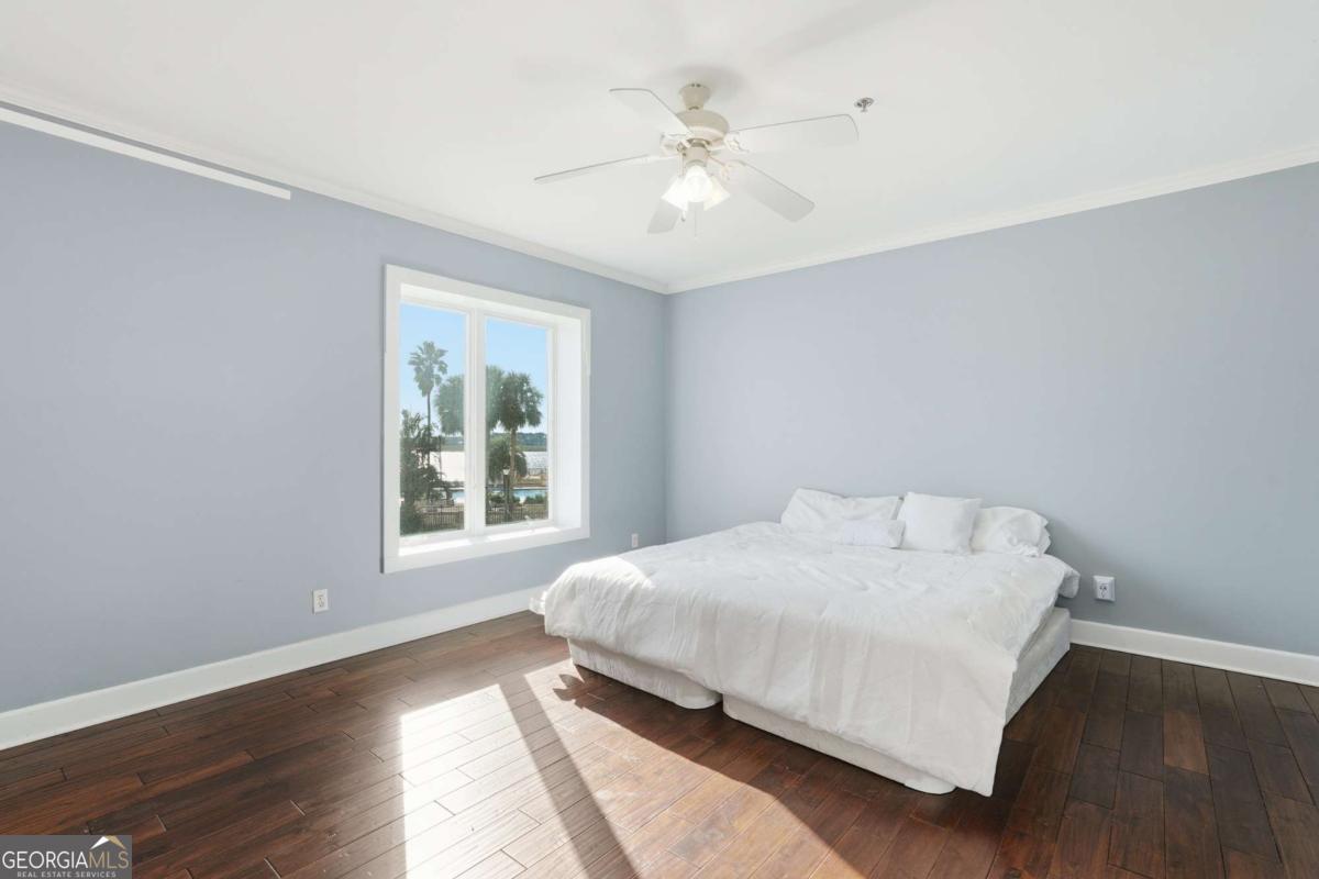 700 Wilmington Island Road, Unit 201 Savannah, GA 31410 - Photo 32 of 51 a bedroom with a large bed and a window