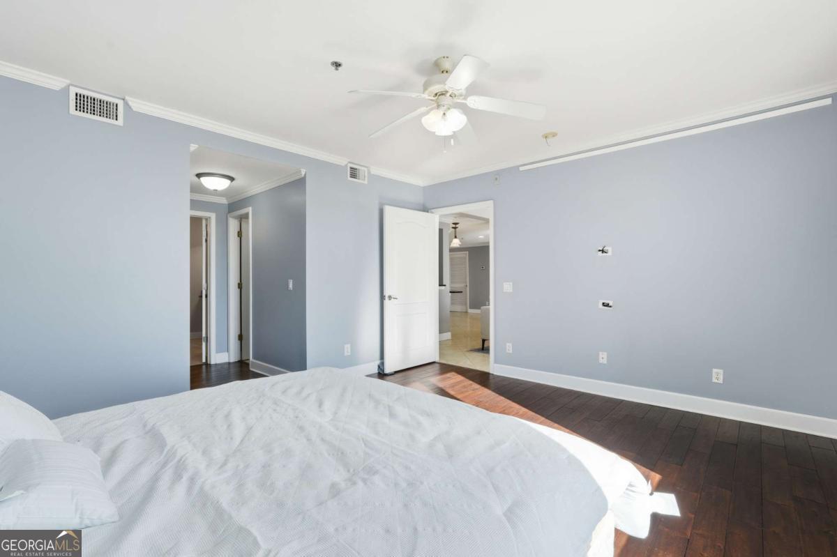 700 Wilmington Island Road, Unit 201 Savannah, GA 31410 - Photo 34 of 51 a bedroom with a bed and a chandelier