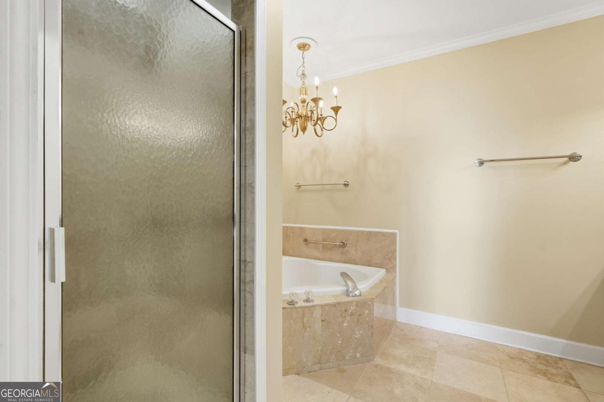 700 Wilmington Island Road, Unit 201 Savannah, GA 31410 - Photo 39 of 51 a bathroom with a glass shower door
