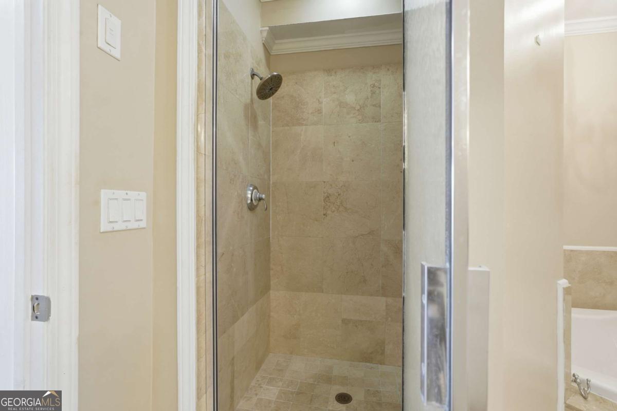 700 Wilmington Island Road, Unit 201 Savannah, GA 31410 - Photo 40 of 51 a bathroom with a glass shower door