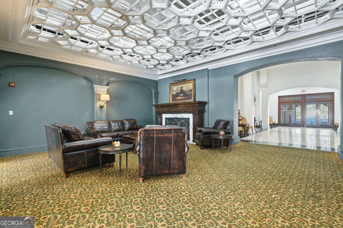 700 Wilmington Island Road, Unit 201 Savannah, GA 31410 - Photo 4 of 51 a living room with furniture and a fireplace