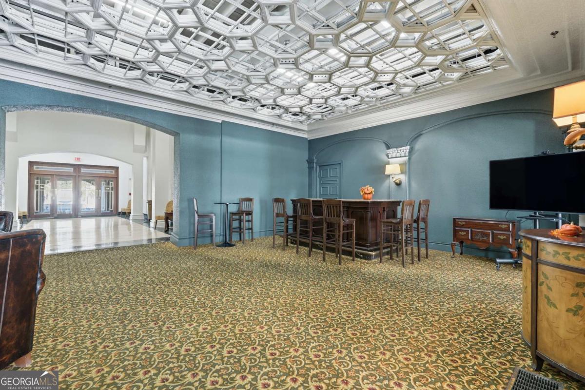 700 Wilmington Island Road, Unit 201 Savannah, GA 31410 - Photo 5 of 51 a room with furniture and a flat screen tv