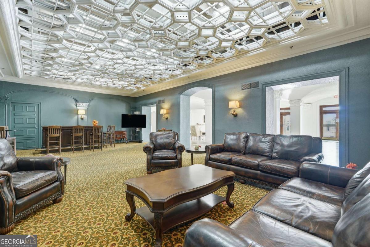 700 Wilmington Island Road, Unit 201 Savannah, GA 31410 - Photo 7 of 51 a living room with furniture and a large mirror