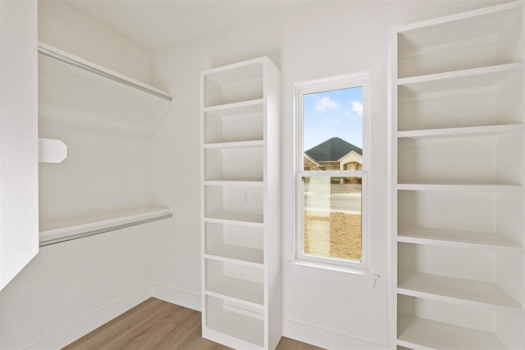 506 Limestone Circle Mabank, TX 75147 - Photo 17 of 33 a view of a closet area with wooden floor