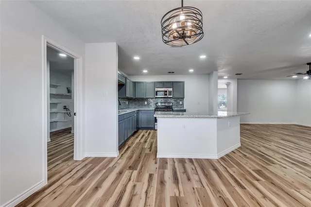 a view of kitchen with cabinets and wooden floor