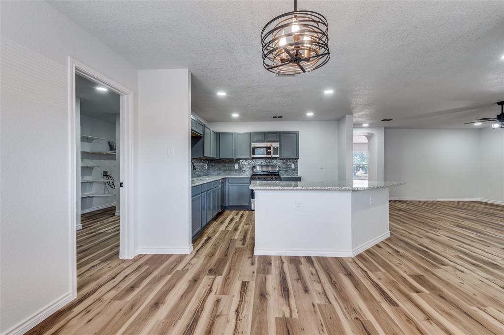 6524 Willow Oak Court Fort Worth, TX 76112 - Photo 13 of 15 a view of kitchen with cabinets and wooden floor