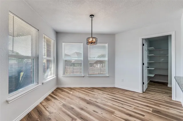 a view of empty room with windows and entryway