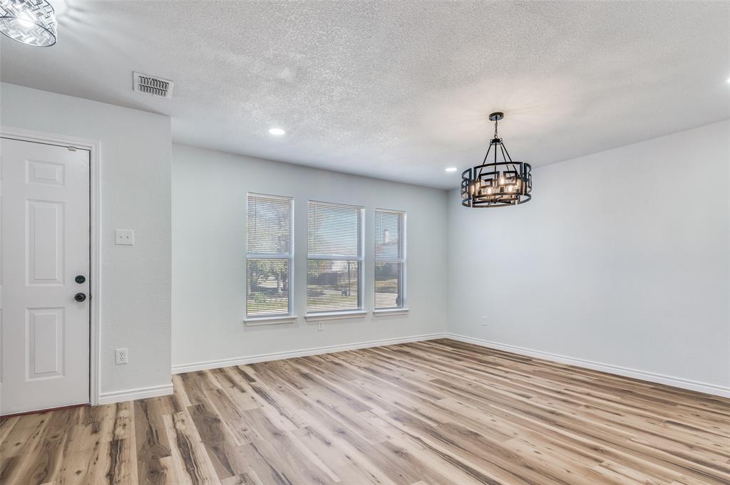 6524 Willow Oak Court Fort Worth, TX 76112 - Photo 2 of 15 wooden floor in an empty room with a window
