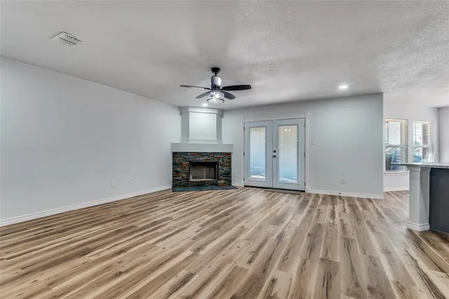 wooden floor in an empty room with a fireplace