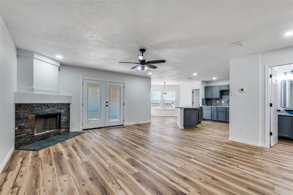 6524 Willow Oak Court Fort Worth, TX 76112 - Photo 6 of 15 a view of empty room with wooden floor and fireplace