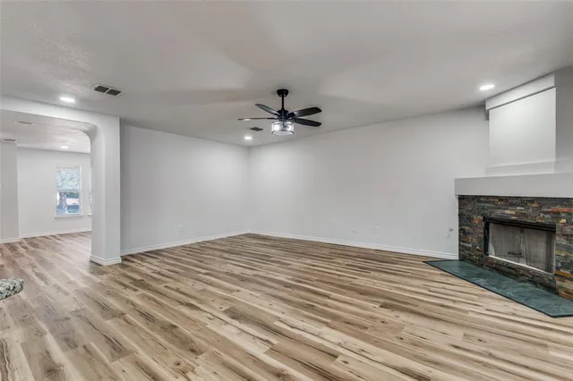 wooden floor in an empty room with a fireplace