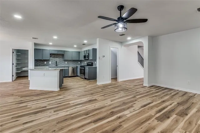 a view of kitchen with cabinets microwave and refrigerator