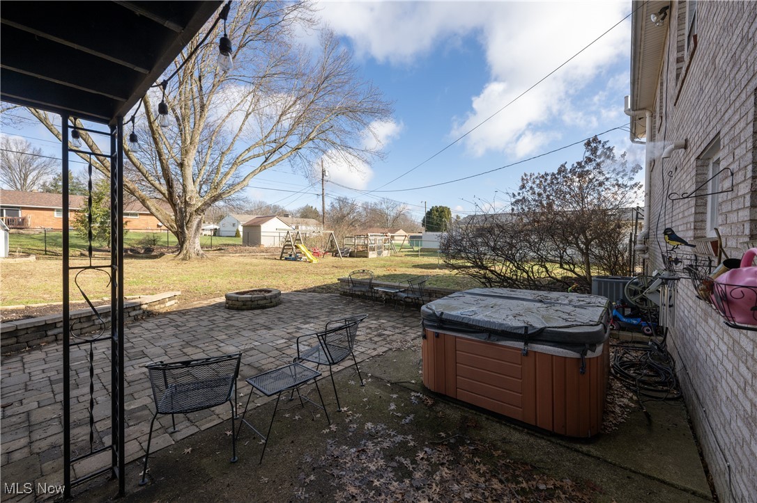 3721 20th Street Northwest Canton, OH 44708 - Photo 33 of 47 View of patio with an outdoor fire pit, a hot tub, and a playground