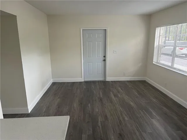 a view of a kitchen from a hallway