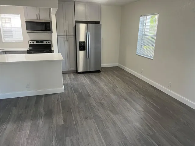 a view of an empty room and wooden floor