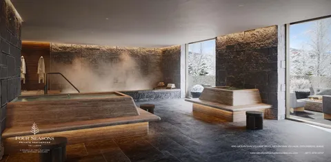 a bedroom with two beds and a lamp