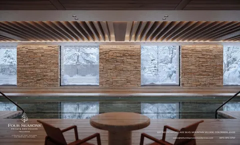 a view of staircase with a rug and a large window