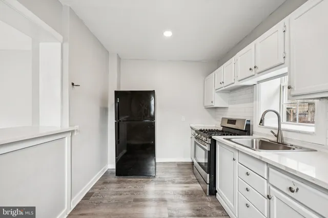 a kitchen with stainless steel appliances granite countertop a refrigerator and a sink