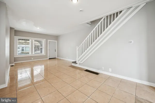 a view of an empty room with stairs