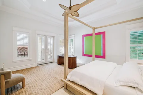 a spacious bedroom with a bed and a table in it