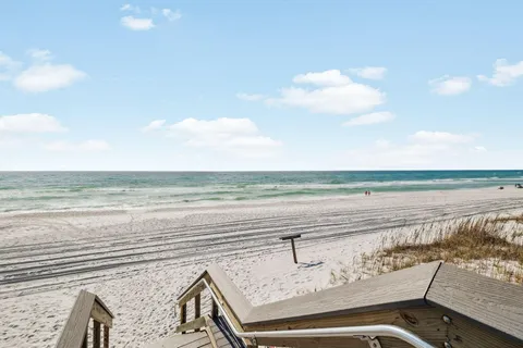 an aerial view of a house with swimming pool and outdoor seating